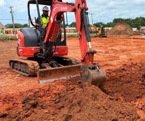 Kelvin Electric crew working on a commercial electrical project, digging into Oklahoma red dirt.